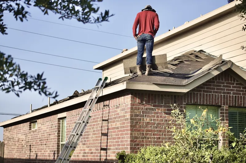 Professional roofer working on a residential roof in Rhododendron